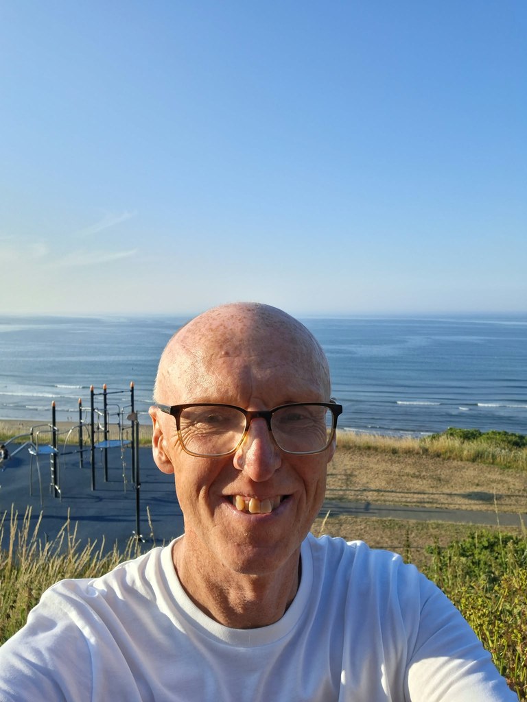 Rob, your local Greensmith driving instructor, smiling by the sea.